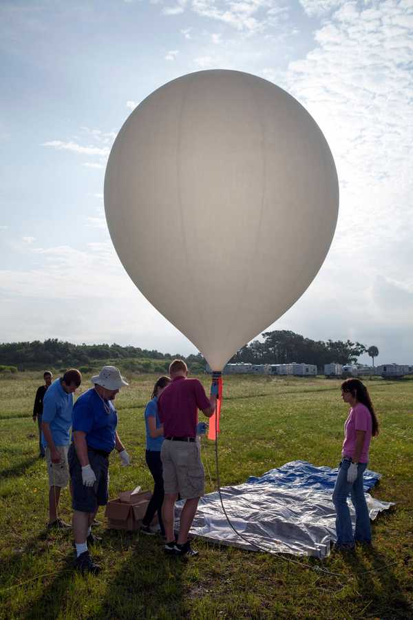 Group of people launching a balloon