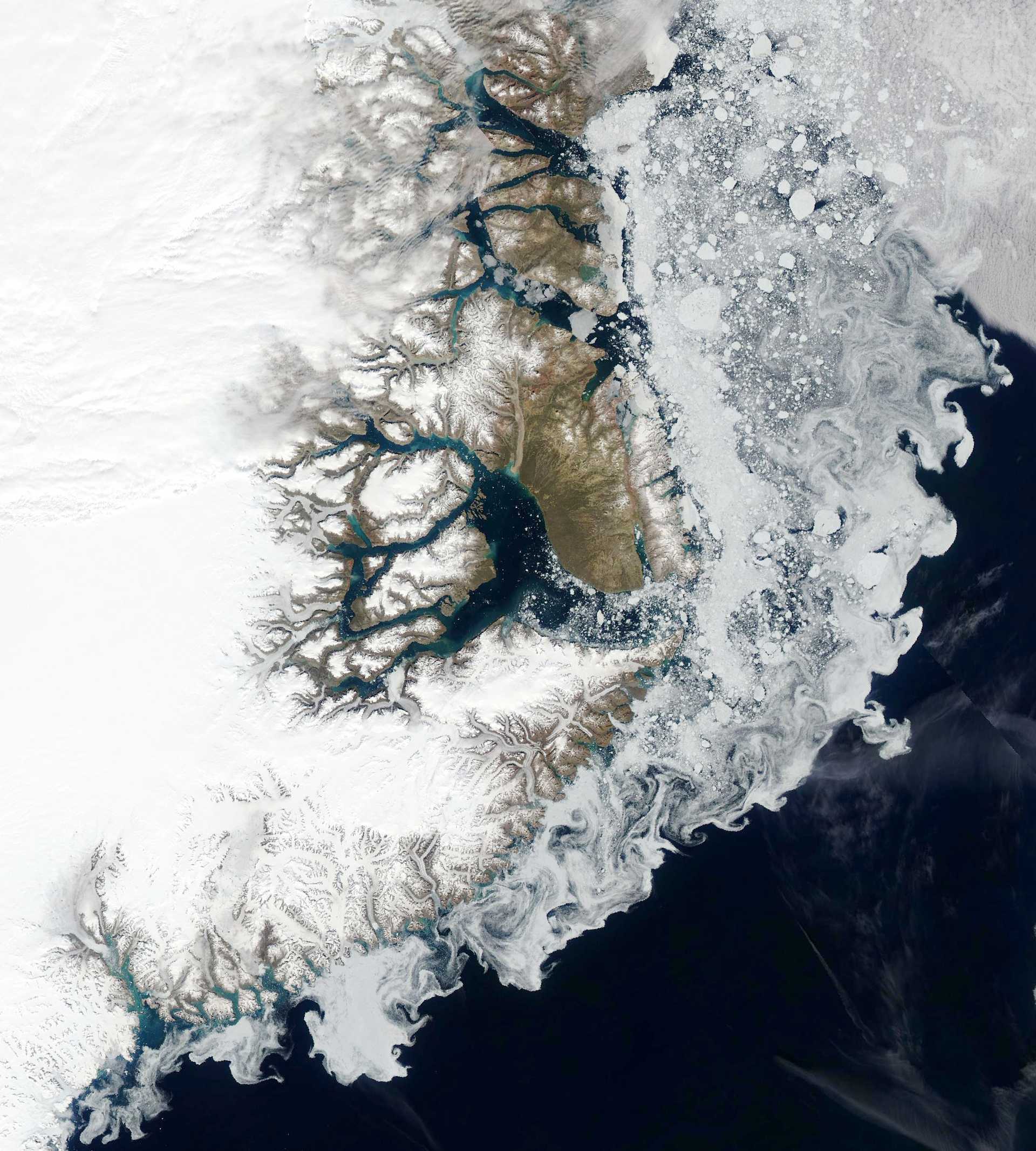 Sea ice hugging the coast of East Greenland. (Photography courtesy NASA/GSFC)