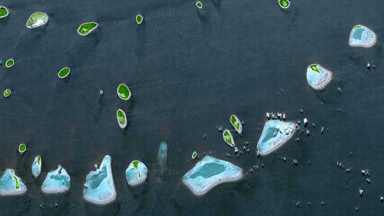 The Republic of Maldives with its twenty-six atolls, and 1192 coral islands, with an average ground elevation of 1.5 meters (about 5 feet). (Photography courtesy NASA/Climate)