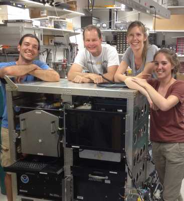 Image of the NOAA AMP instrument team with the AMP sensor